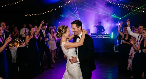Couple’s first dance under purple uplighting